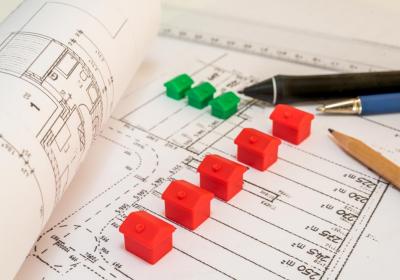 Symbolbild: Spielzeughäuser auf Architekturzeichnungen